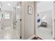Hallway view into a bedroom and bathroom with tiled flooring and neutral paint at 412 Middleton Dr., Pawleys Island, SC 29585