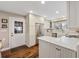 Well-lit kitchen featuring white cabinets, stainless steel appliances, and hardwood floors at 412 Middleton Dr., Pawleys Island, SC 29585