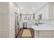 Modern kitchen featuring white cabinetry, stainless steel appliances, and stylish hardwood flooring at 412 Middleton Dr., Pawleys Island, SC 29585