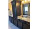 Bathroom with black cabinetry, granite countertops, double sinks and built-in storage at 429 Oakham Dr., Conway, SC 29526