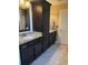 Bathroom with black cabinetry, granite countertops, double sinks, and a separate door to the toilet and shower at 429 Oakham Dr., Conway, SC 29526