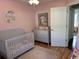 Pink bedroom with a crib, dresser and hardwood floors at 429 Oakham Dr., Conway, SC 29526