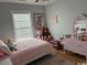 bedroom with a twin bed, large sunny window and decorative artwork at 429 Oakham Dr., Conway, SC 29526