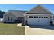 Charming single-story home features a well-manicured lawn, two-car garage, and covered front entry at 429 Oakham Dr., Conway, SC 29526