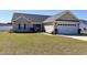 Lovely home with an attached garage, a landscaped lawn and an inviting front entryway at 429 Oakham Dr., Conway, SC 29526