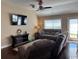 Cozy living area with a TV, wood flooring, a ceiling fan, and access to the backyard at 429 Oakham Dr., Conway, SC 29526