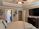 Bright main bedroom features a ceiling fan, a tray ceiling, and access to the ensuite bathroom at 429 Oakham Dr., Conway, SC 29526