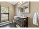 Bathroom featuring a dark wood vanity with a marble countertop, a large mirror, and tile floors at 4450 Little River Inn Ln. # 601, Little River, SC 29566