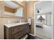 Bathroom vanity with a framed mirror and a doorway leading to a bedroom at 4450 Little River Inn Ln. # 601, Little River, SC 29566