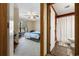 A well-lit bedroom featuring a ceiling fan, window, and doorway leading to a bathroom at 4450 Little River Inn Ln. # 601, Little River, SC 29566