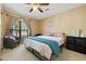 Cozy bedroom featuring neutral decor, a ceiling fan, and a large window for natural light at 4450 Little River Inn Ln. # 601, Little River, SC 29566