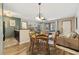 Cozy dining area adjacent to the kitchen and living room with a view of the outdoor patio at 4450 Little River Inn Ln. # 601, Little River, SC 29566