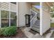 Home entrance with decorative wreath on the door, open stairs, and lush landscaping at 4450 Little River Inn Ln. # 601, Little River, SC 29566