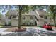 Charming exterior view of the two-story home showcasing the multiple windows and front parking at 4450 Little River Inn Ln. # 601, Little River, SC 29566