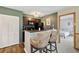 Convenient kitchen with bar seating, view to the living room, and modern dark appliances at 4450 Little River Inn Ln. # 601, Little River, SC 29566