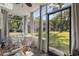 Enclosed back patio with seating area, curtains, and screened door leading to yard at 4450 Little River Inn Ln. # 601, Little River, SC 29566