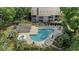 Aerial view of a community pool featuring lounge chairs, a hot tub, and tropical landscaping at 4450 Little River Inn Ln. # 601, Little River, SC 29566