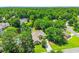 Aerial view of homes in a wooded neighborhood featuring a pond and some residences with pools at 4499 Firethorne Dr., Murrells Inlet, SC 29576