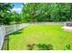 A large grassy backyard enclosed by a white picket fence, offering a safe and spacious area at 4499 Firethorne Dr., Murrells Inlet, SC 29576
