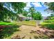 View of the back yard with a white fence, landscaping, and partial view of a home with a covered porch at 4499 Firethorne Dr., Murrells Inlet, SC 29576