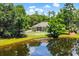 Picturesque backyard with a pond view, white picket fence, and screened-in porch at 4499 Firethorne Dr., Murrells Inlet, SC 29576