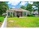 A backyard with a screened in porch, grill, green grass, and a white picket fence at 4499 Firethorne Dr., Murrells Inlet, SC 29576