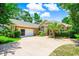 Attractive brick home with an attached garage, lush landscaping, and a welcoming driveway at 4499 Firethorne Dr., Murrells Inlet, SC 29576