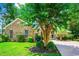 Beautiful brick home with a well-kept lawn, mature tree, and inviting front entrance at 4499 Firethorne Dr., Murrells Inlet, SC 29576