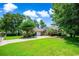 Charming brick home featuring a well-manicured lawn, mature trees, and a spacious driveway at 4499 Firethorne Dr., Murrells Inlet, SC 29576