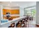 Modern kitchen with breakfast bar, stainless steel appliances, and adjacent dining area with lots of sunlight at 4499 Firethorne Dr., Murrells Inlet, SC 29576