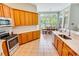 Bright kitchen boasts ample cabinet space, stainless steel appliances, and a scenic view of the backyard at 4499 Firethorne Dr., Murrells Inlet, SC 29576