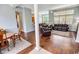 Open-concept living room featuring hardwood floors, neutral walls, and a breakfast bar at 4499 Firethorne Dr., Murrells Inlet, SC 29576