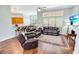 Comfortable living room with hardwood floors, large windows, and a view of the breakfast bar at 4499 Firethorne Dr., Murrells Inlet, SC 29576