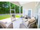 Screened-in patio features cozy seating and views of the expansive, fenced backyard at 4499 Firethorne Dr., Murrells Inlet, SC 29576