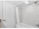 Clean bathroom with a tub and shower combination, tiled walls, and a shower curtain at 4800 S Ocean Blvd. # 1524, North Myrtle Beach, SC 29582