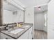 Bathroom featuring double sinks, granite countertop and a large decorative mirror at 4800 S Ocean Blvd. # 1524, North Myrtle Beach, SC 29582
