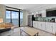 Cozy kitchen features modern appliances, bright white cabinets, and a scenic view of the ocean from the sliding glass door at 4800 S Ocean Blvd. # 1524, North Myrtle Beach, SC 29582
