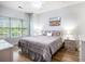 Bright bedroom features a ceiling fan, wood floors, and a large window providing natural light at 4868 Dahlia Ct. # 202, Myrtle Beach, SC 29577