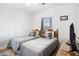 This bedroom features two twin beds, a window, and a TV at 4868 Dahlia Ct. # 202, Myrtle Beach, SC 29577