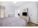 This bedroom has wood floors, a TV, and opens to the home's other rooms at 4868 Dahlia Ct. # 202, Myrtle Beach, SC 29577