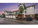 Exterior shot of condo building featuring garage parking and multiple balconies at 4868 Dahlia Ct. # 202, Myrtle Beach, SC 29577