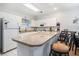 Bright kitchen with white cabinets, modern appliances, and breakfast bar with stool seating at 4868 Dahlia Ct. # 202, Myrtle Beach, SC 29577