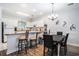 Well-lit kitchen featuring an island with barstool seating and a dining area with a chandelier at 4868 Dahlia Ct. # 202, Myrtle Beach, SC 29577