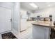 Bright kitchen with white cabinets, modern appliances, and breakfast bar with stool seating at 4868 Dahlia Ct. # 202, Myrtle Beach, SC 29577