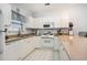Bright kitchen with white cabinets and appliances, featuring a breakfast bar with seating at 4868 Dahlia Ct. # 202, Myrtle Beach, SC 29577
