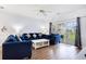 Bright living room featuring hardwood floors, comfortable seating, and a sliding glass door to the outside at 4868 Dahlia Ct. # 202, Myrtle Beach, SC 29577