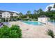 Community pool featuring lounge chairs and a pool house, surrounded by greenery and palm trees at 4868 Dahlia Ct. # 202, Myrtle Beach, SC 29577