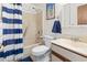 Bathroom with a shower-tub combo, blue striped shower curtain, and a white single sink vanity at 500 Fairway Village Dr. # J-7, Myrtle Beach, SC 29588