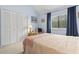 Bedroom featuring a large window, vaulted ceilings, and closet with shutter doors at 500 Fairway Village Dr. # J-7, Myrtle Beach, SC 29588