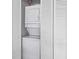 Close-up view of a stacked washer and dryer with bi-fold doors at 500 Fairway Village Dr. # J-7, Myrtle Beach, SC 29588